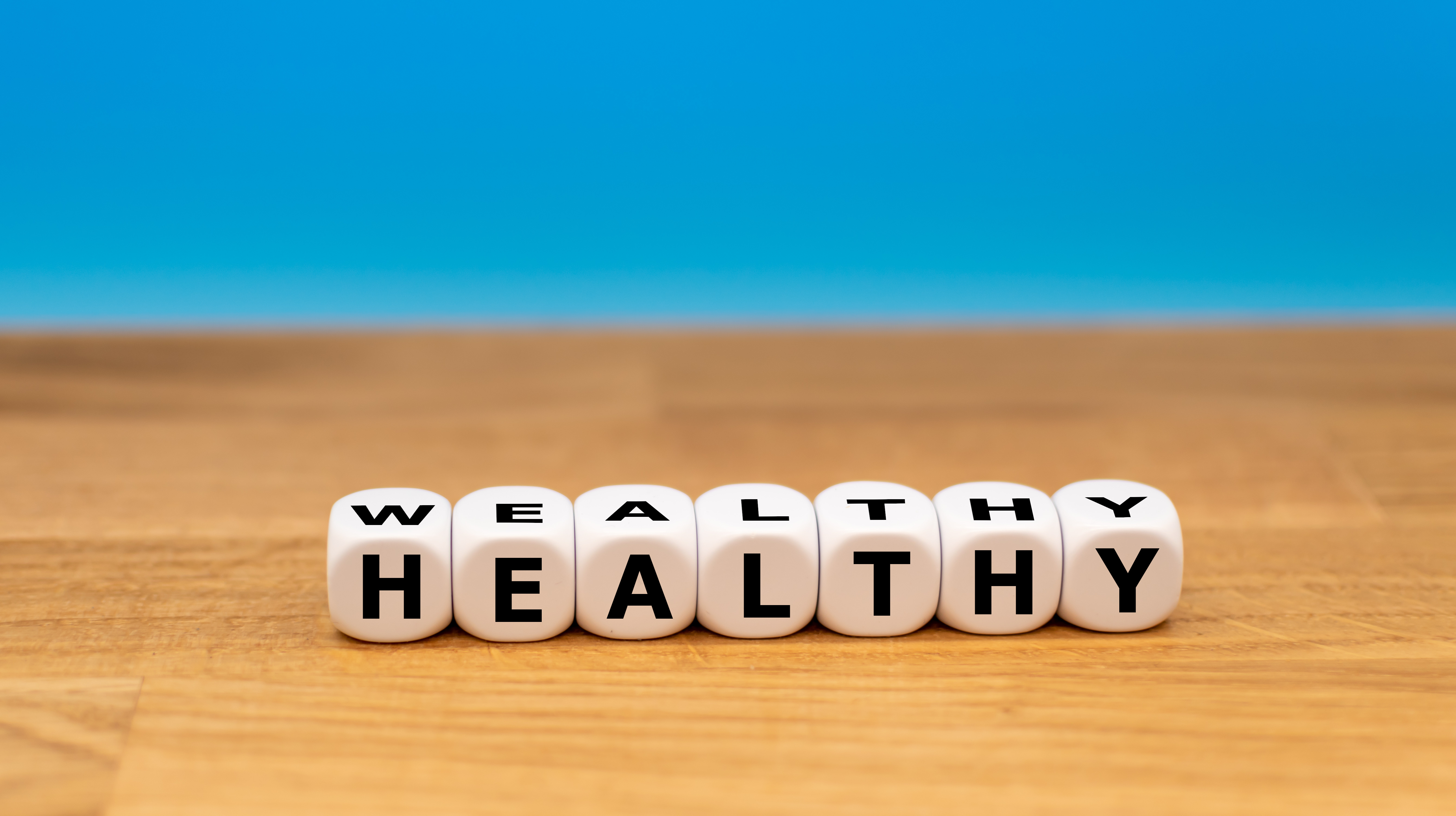 Dice form the words "wealthy" and "healthy"