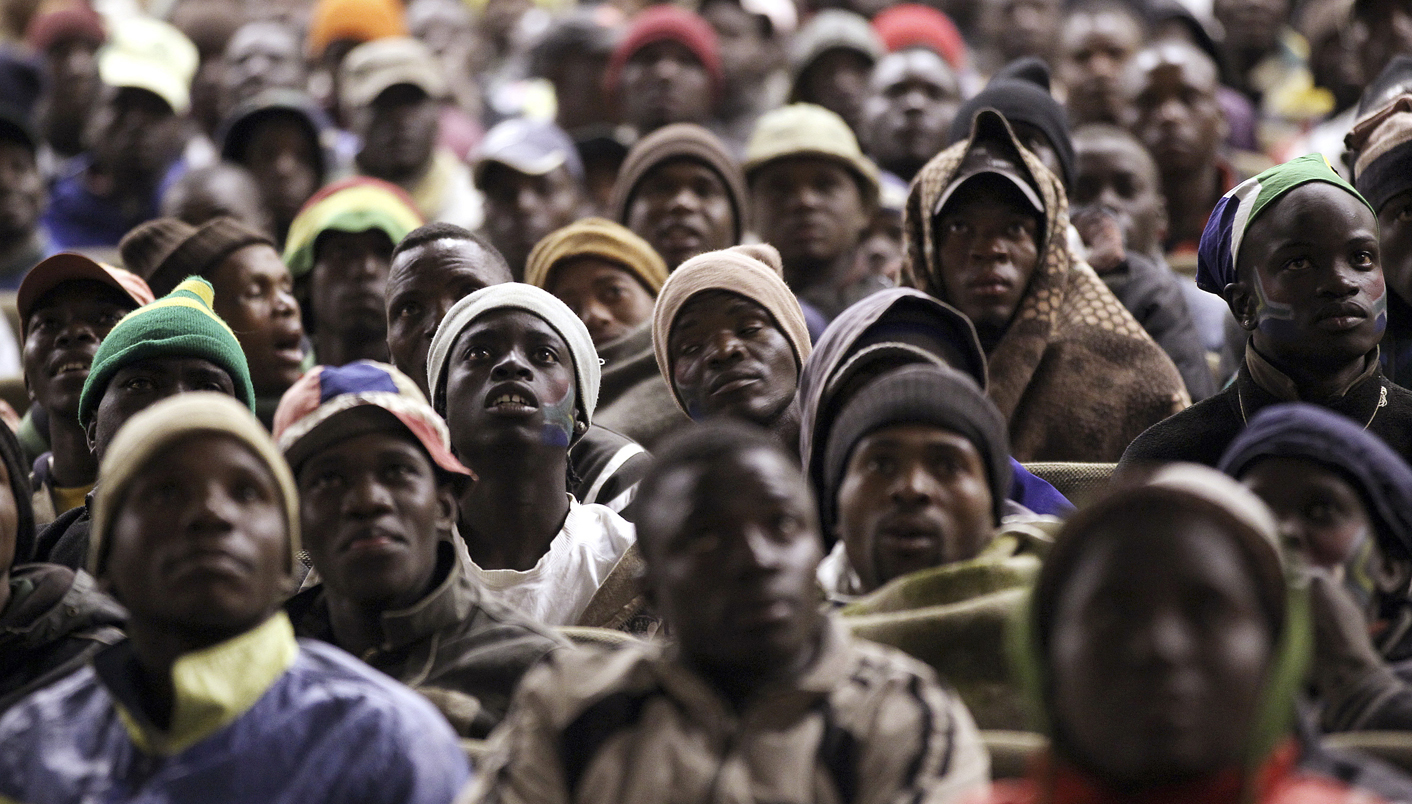 Homeless people watch the World Cup Group A Soccer match between South Africa and Uruguay in the suburb of Pretoria