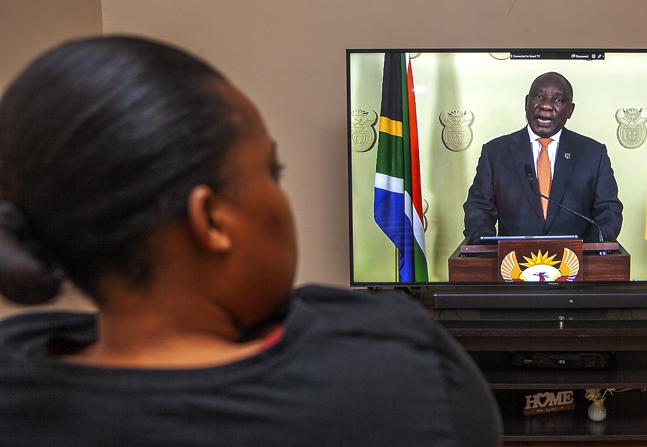 SA citizen listens to President Cyril Ramphosa as he addresses the Nation