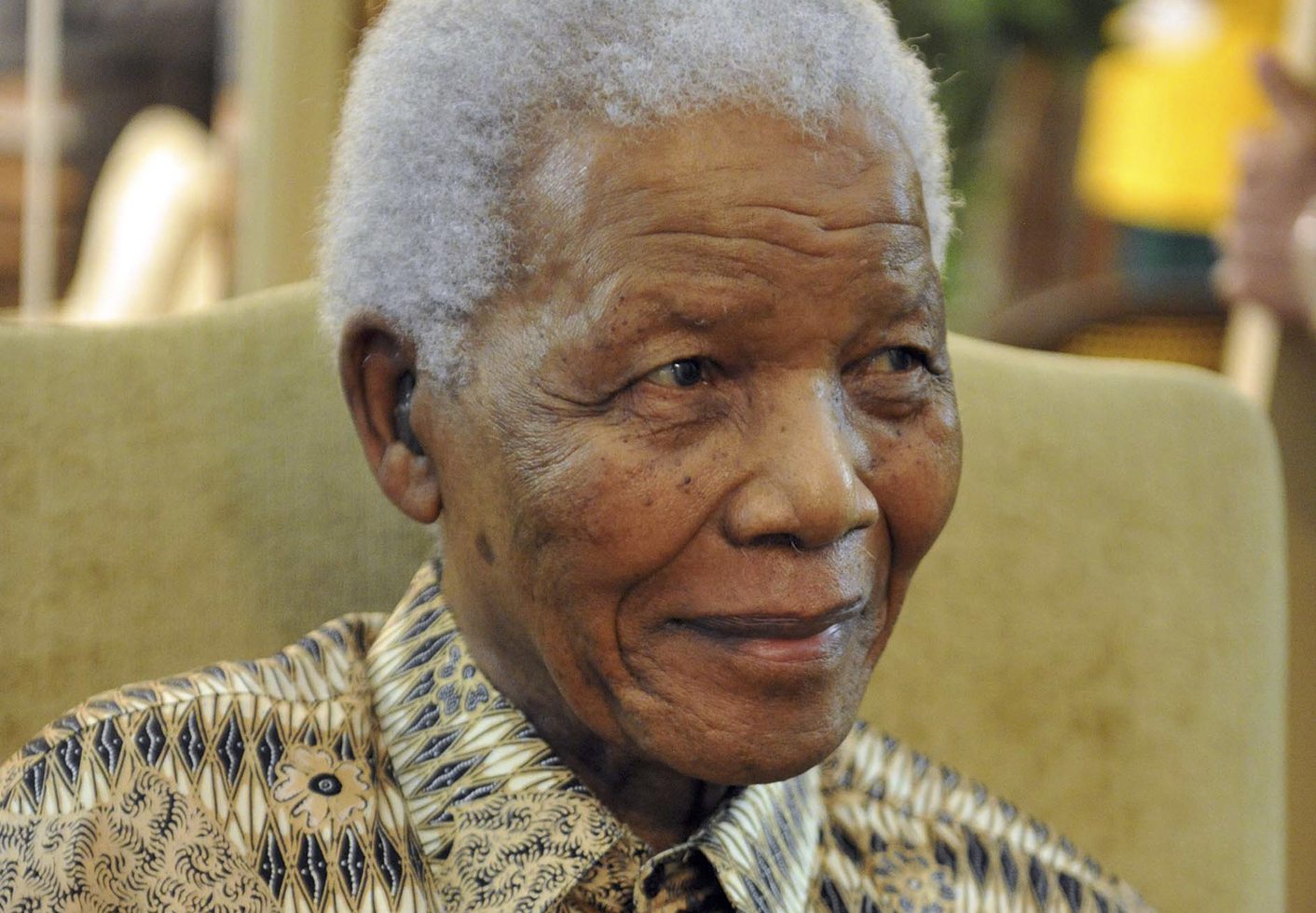 Former South African President Nelson Mandela smiles after casting his vote for the upcoming May 18 elections, at home in Houghton
