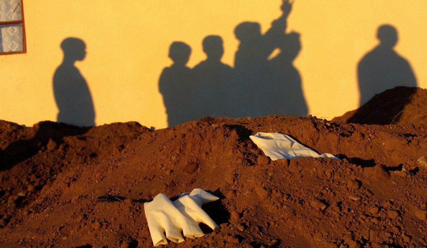 Residents of the Mandela Park informal settlement outside Umtata, South Africa, gather at the site where eight bodies were exhumed