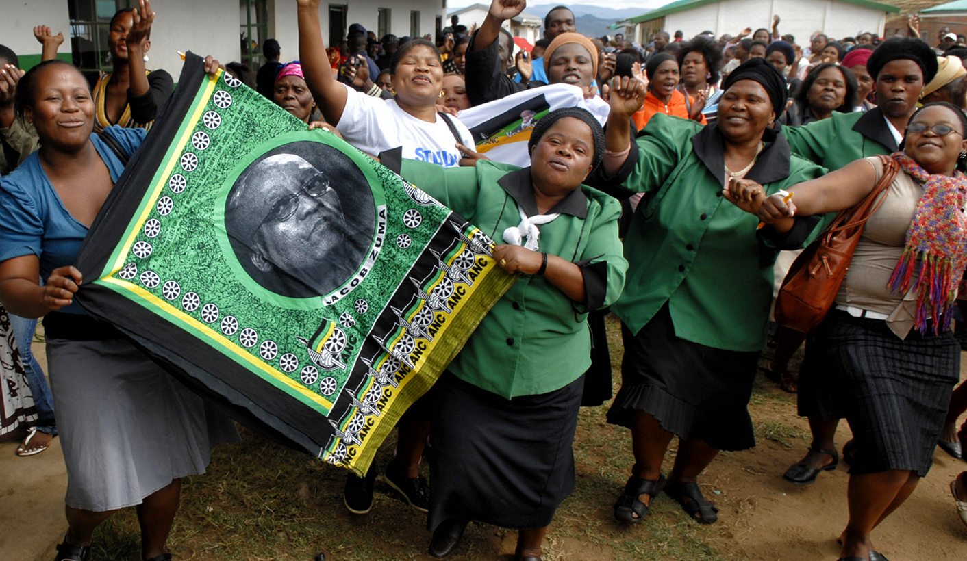 Supporters of South Africa's ruling ANC leader Jacob Zuma sing party songs as he enters the voting station in Nkandla