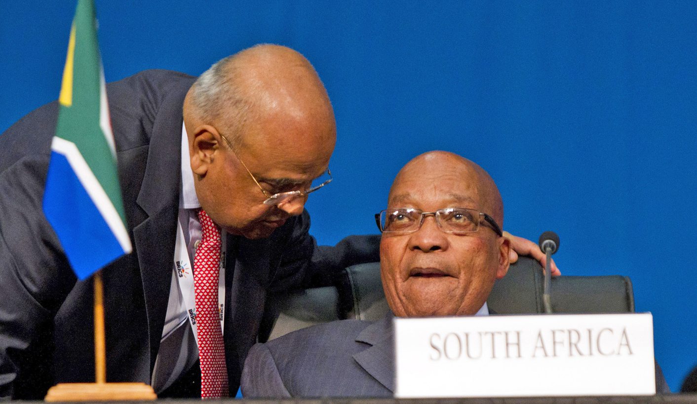 South Africa's Finance Minister Pravin Gordhan speaks to President Jacob Zuma during closing remarks during the 5th BRICS Summit in Durban