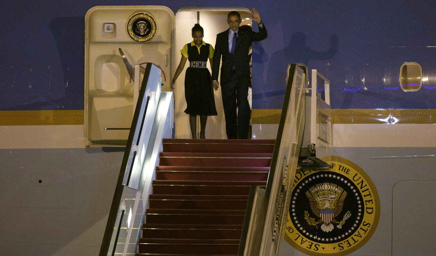 U.S. President Barack Obama waves as he arrives with his daughter Sasha in Dakar airport
