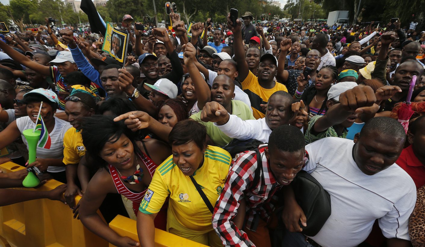 Mourners gather behind police cordons after being denied entry to the site where former President Nelson Mandela was lying in state in Pretoria