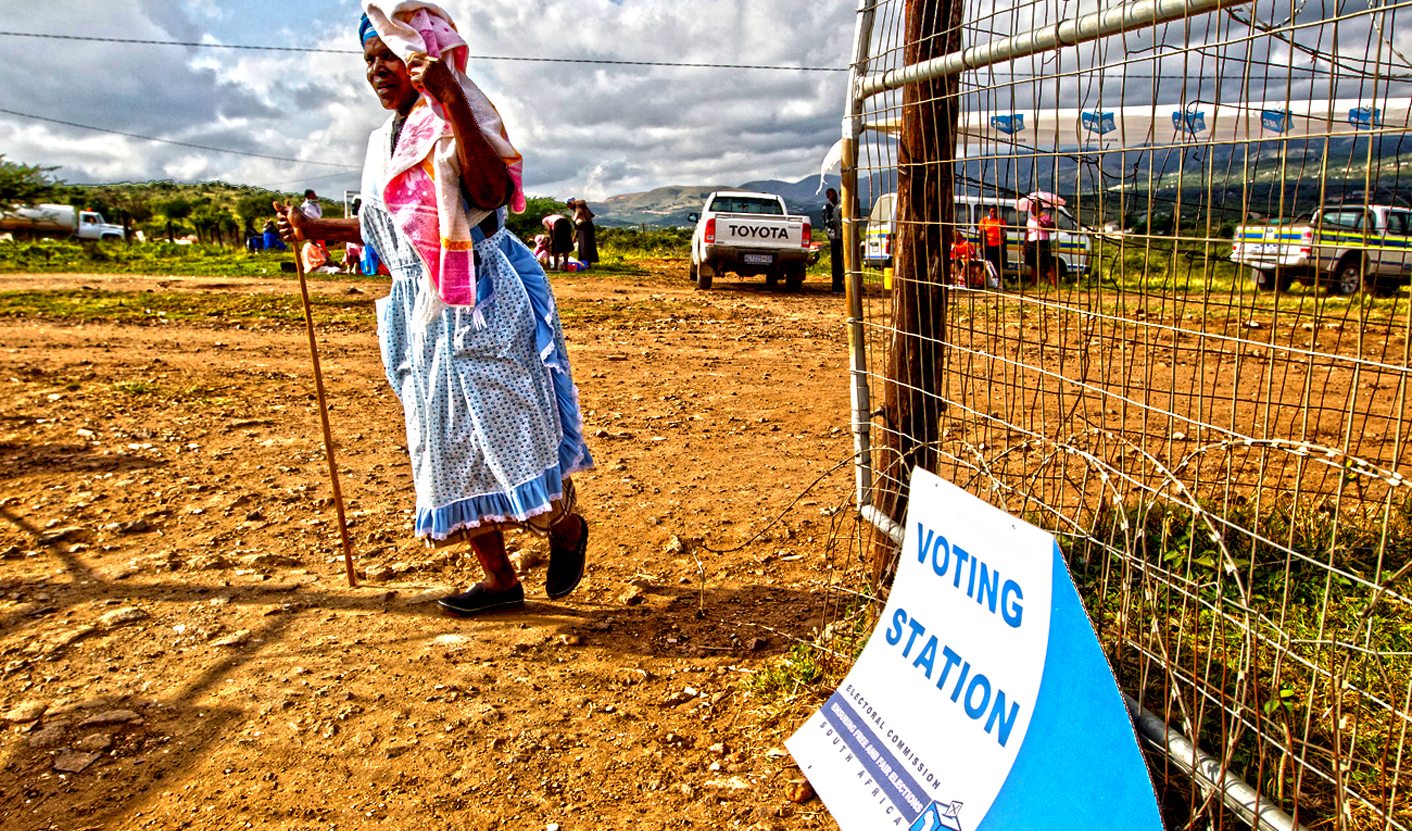 Woman arrives at polling station during South African municipal elections in Nkandla