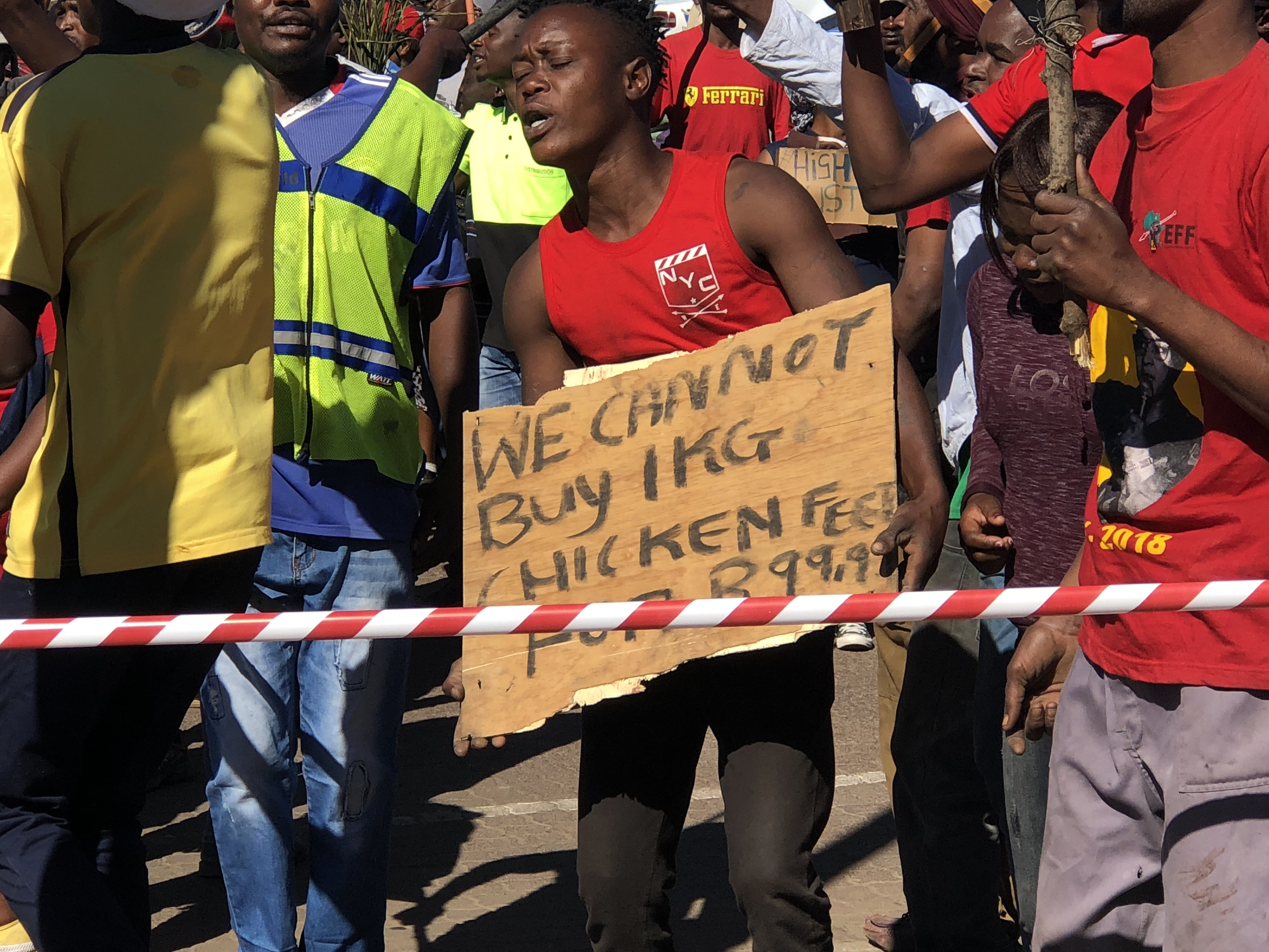 Informal settlement residents march to demand that stores lower food prices