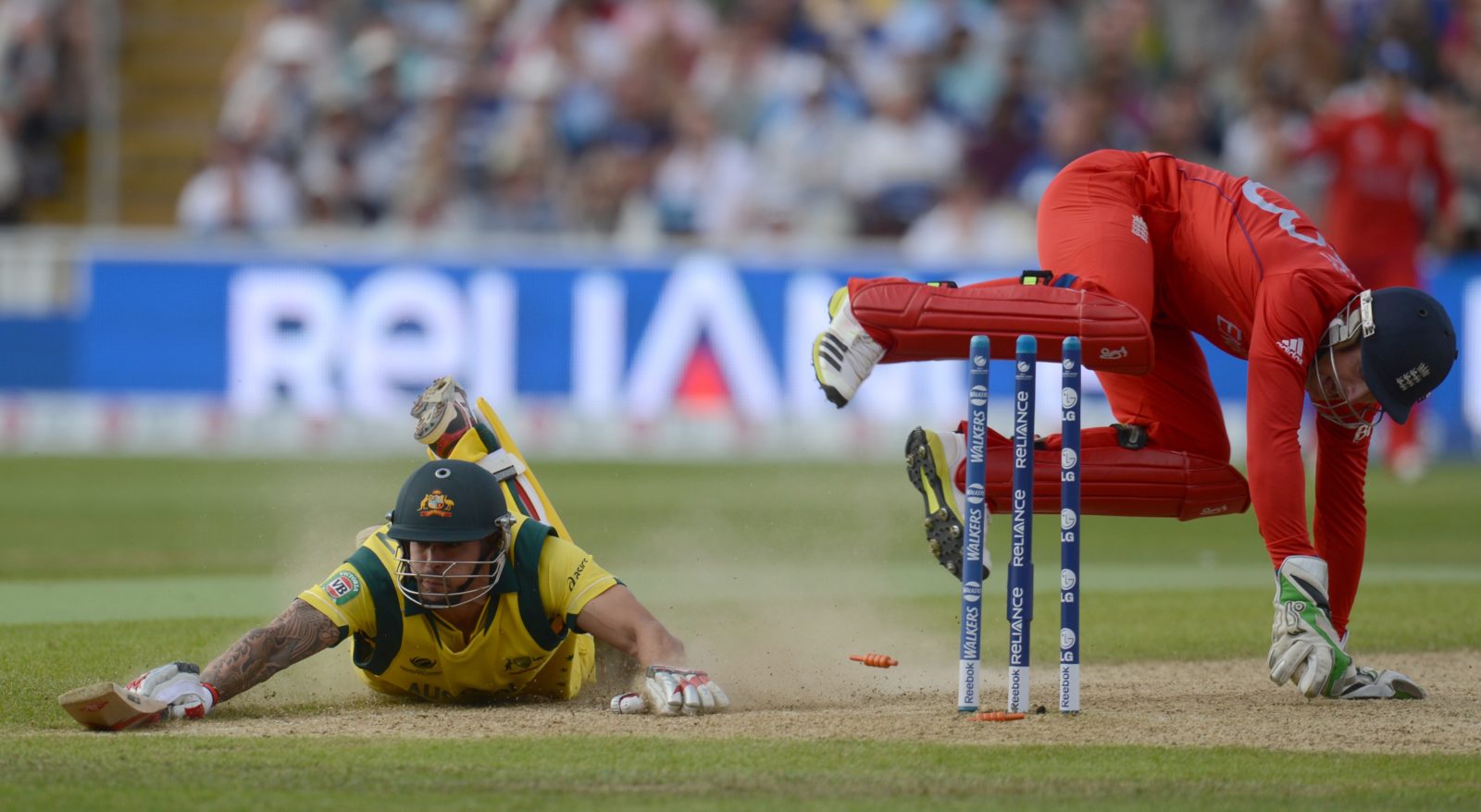 Australia's Johnson just survives a run out attempt by England's Buttler during the ICC Champions Trophy group A match at Edgbaston cricket ground in Birmingham