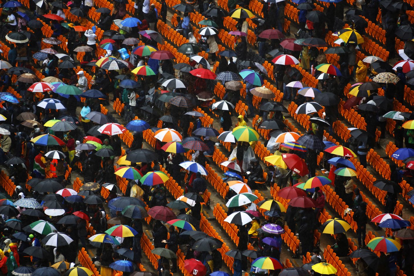 People attend a memorial at the First National Bank Stadium ahead of the national memorial service for late former South African President Nelson Mandela