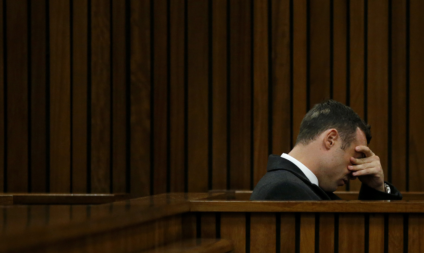 Olympic and Paralympic track star Pistorius sits next to the dock during lunch break at his trial in Pretoria