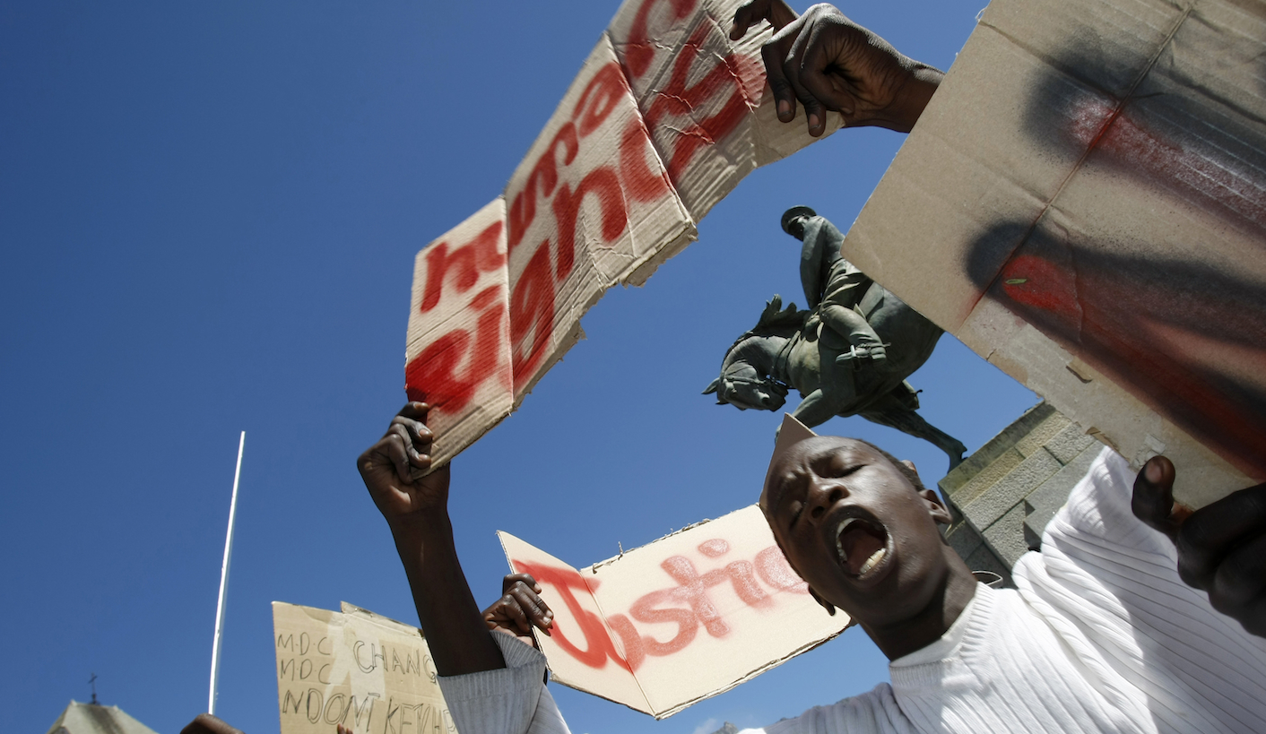 Refugees, mainly from Zimbabwe and Somalia, demonstrate outside the parliament in Cape Town