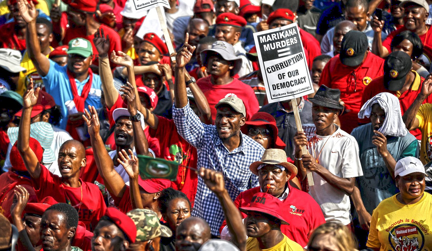 Demonstrators carry placards as they march to the Union building to protest against corruption in Pretoria