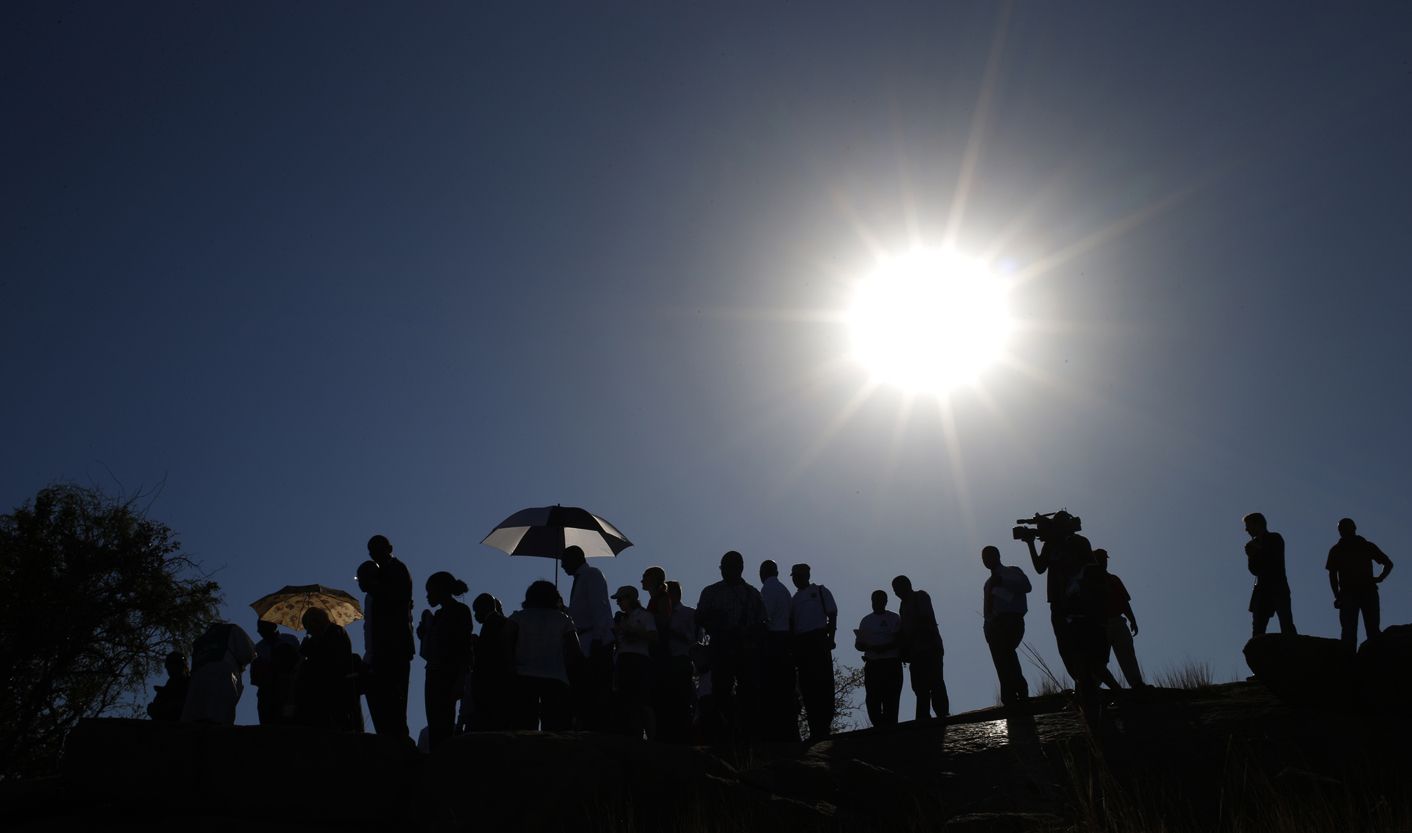 Members of the judicial commission of inquiry into the shootings at Lonmin's Marikana mine and members of the media visit the site