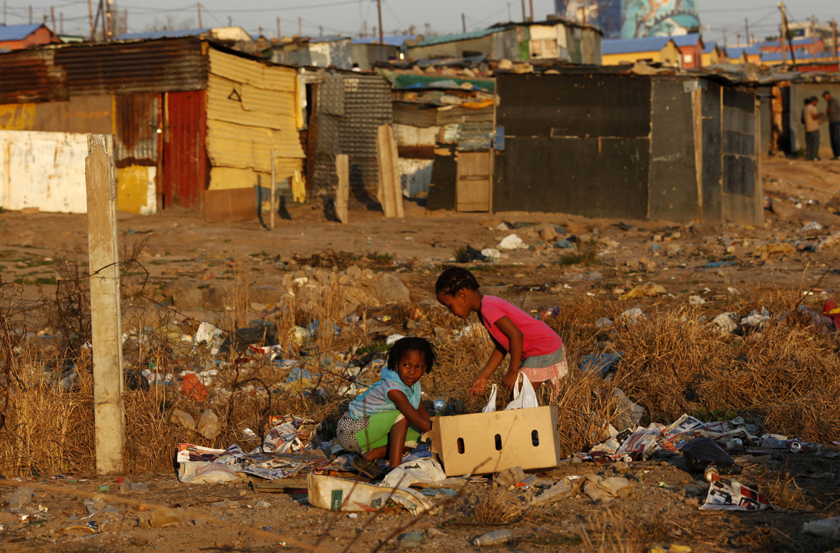Children play at a rubbish dump at an informal settlement in Soweto