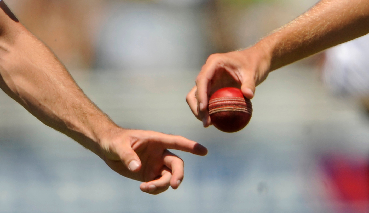 Anderson hands the ball to Broad during the third cricket test match against South Africa at Newlands