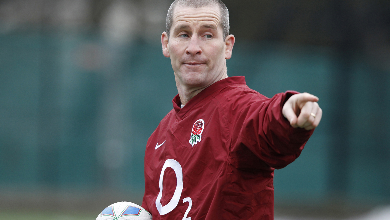 England rugby coach Stuart Lancaster gives instructions during a training session at a school in Woking, southwest of London