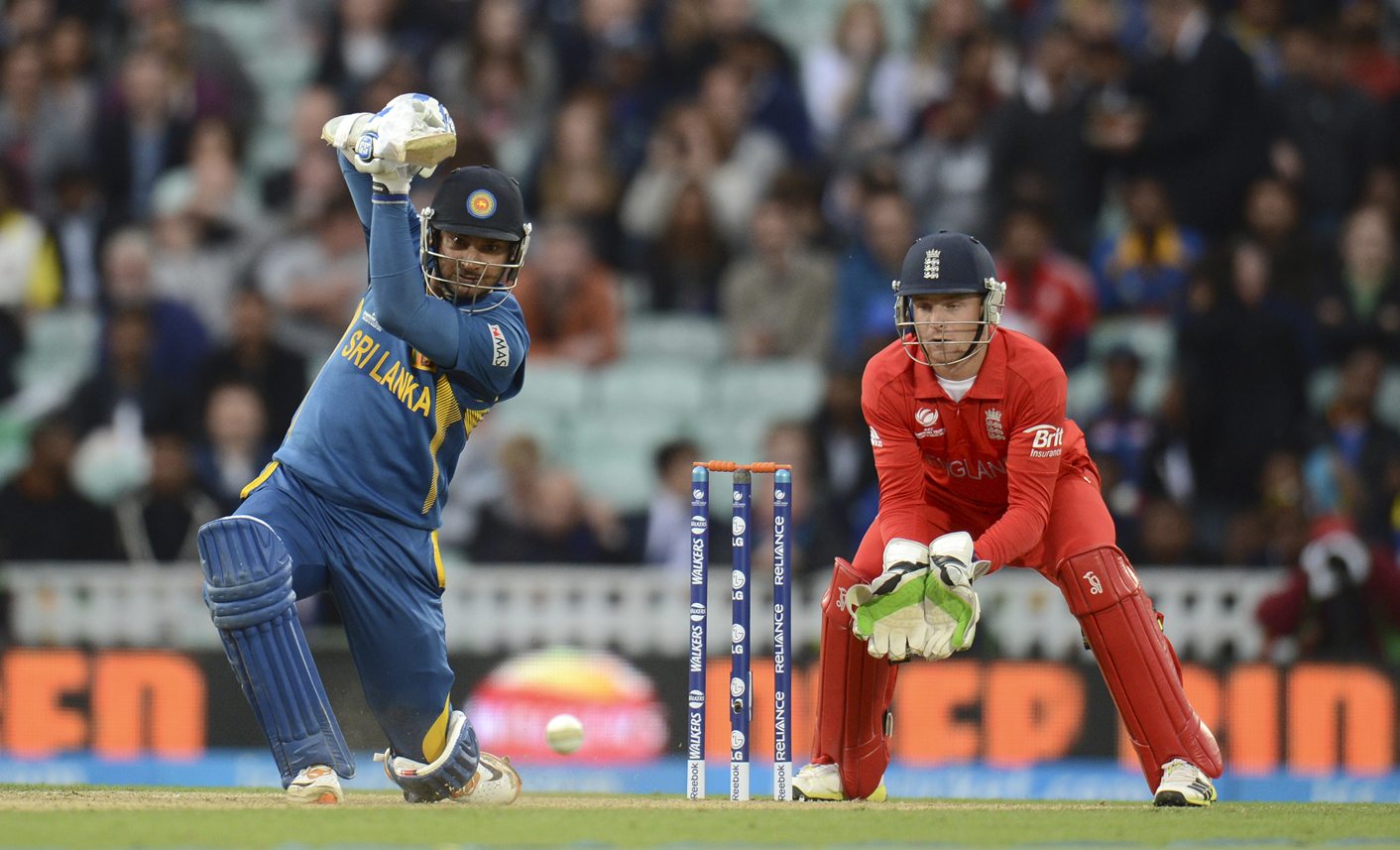 Sri Lanka's Sangakkara hits out watched by England's Buttler during the ICC Champions Trophy group A match at The Oval cricket ground in London