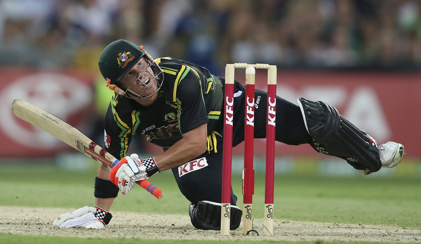 Australia's David Warner hits a six off the bowling of Sri Lanka 's captain Angelo Mathews during their Twenty/20 international cricket match at the Homebush Stadium