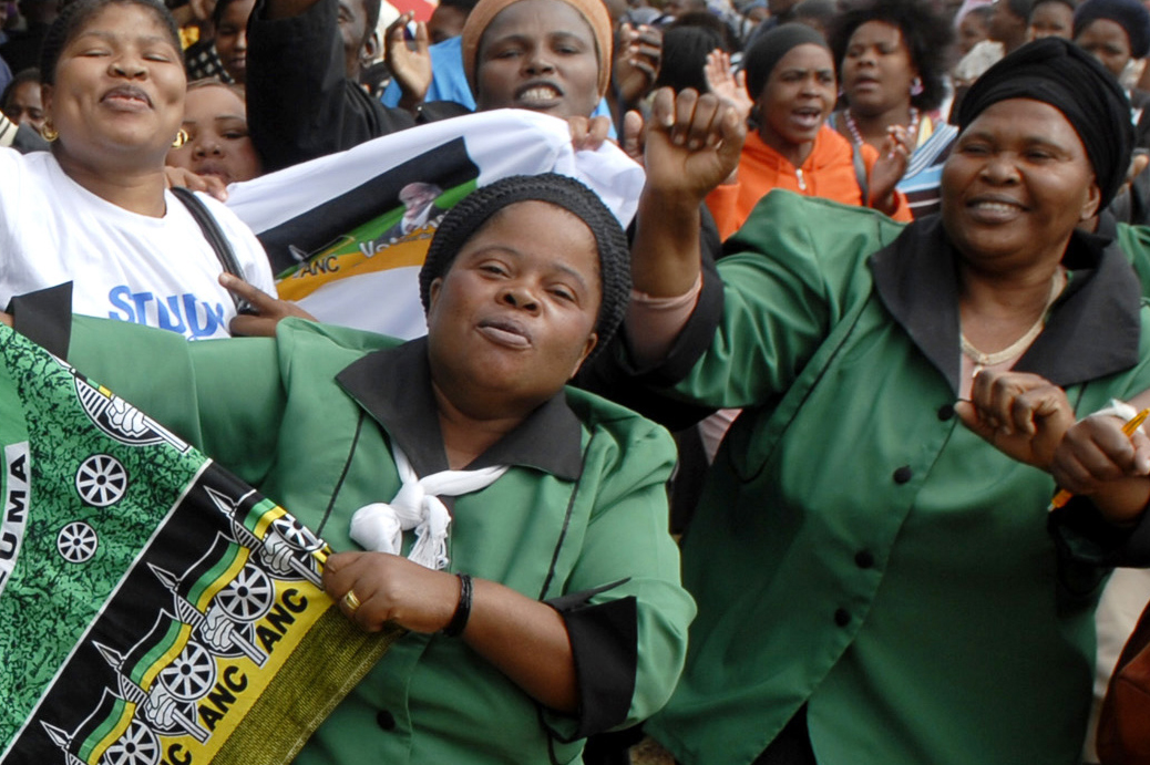Supporters of South Africa's ruling ANC leader Jacob Zuma sing party songs as he enters the voting station in Nkandla