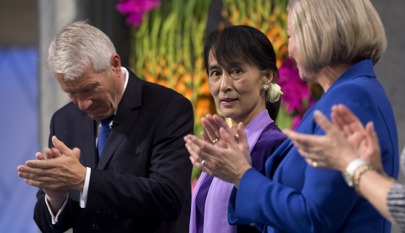 Nobel 1991 Peace Prize Laureate Myanmar pro-democracy leader Suu Kyi stands beside Jagland, chairman of the Norwegian Nobel Committee, as she receives applause after her Nobel lecture, in Oslo