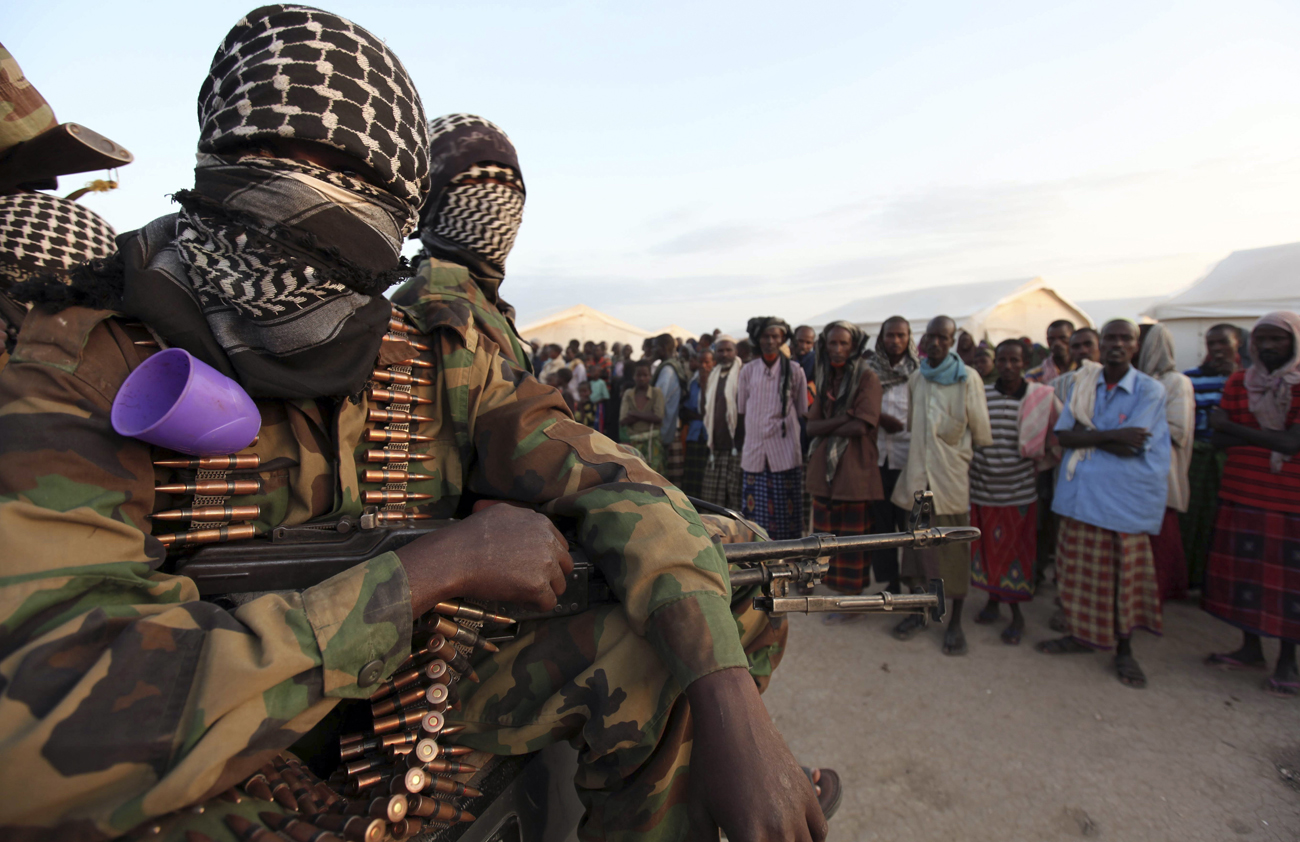 Members of al Shabaab ride in their pick-up trucks after distributing relief to famine stricken internally displaced people at Ala Yaasir camp