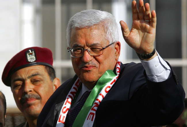 Palestinian President Abbas waves to supporters during a visit to the West Bank city of Hebron