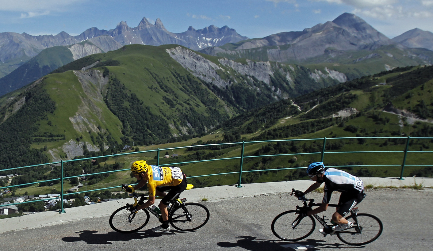 Sky Procycling rider and leader's yellow jersey Wiggins of Britain and compatriot Froome cycle in the Alps mountains during the eleventh stage of the 99th Tour de France cycling race between Albertville and La Toussuire