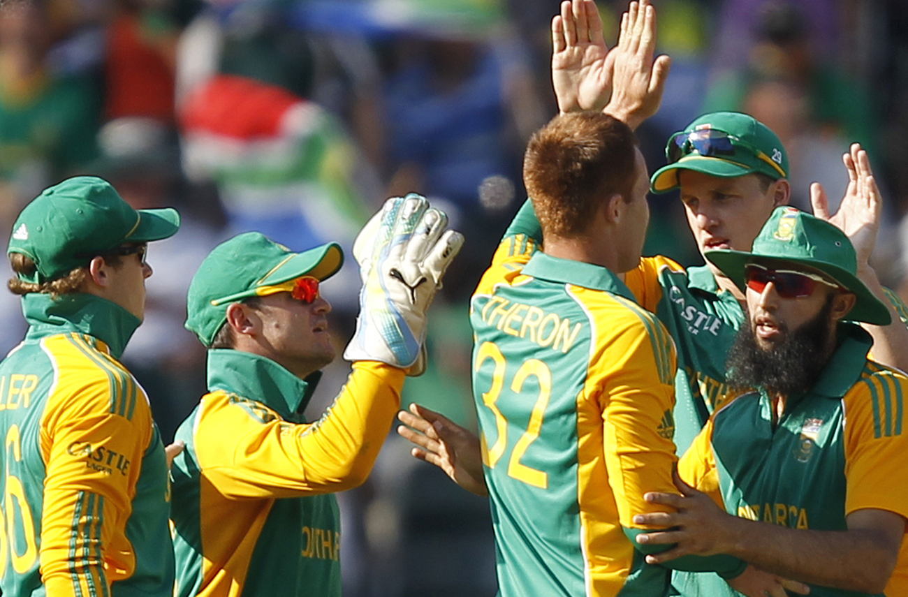 South African players celebrate the dismissal of Steve O'Keefe of Australia who was caught out by Rusty Theron during their second Twenty20 international cricket match in Johannesburg