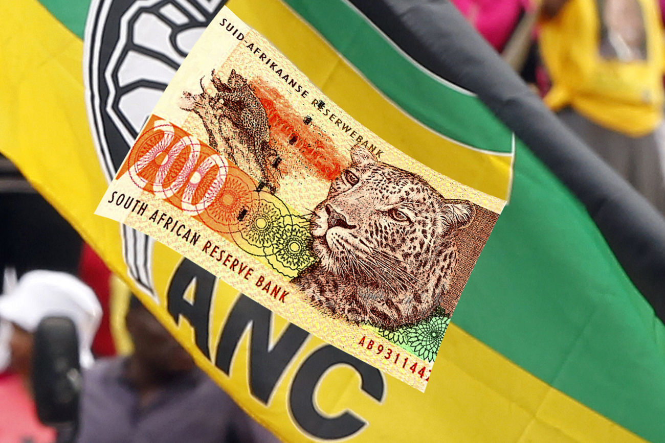 An ANC Youth League supporter gestures in front of an ANC flag during a march in Johannesburg