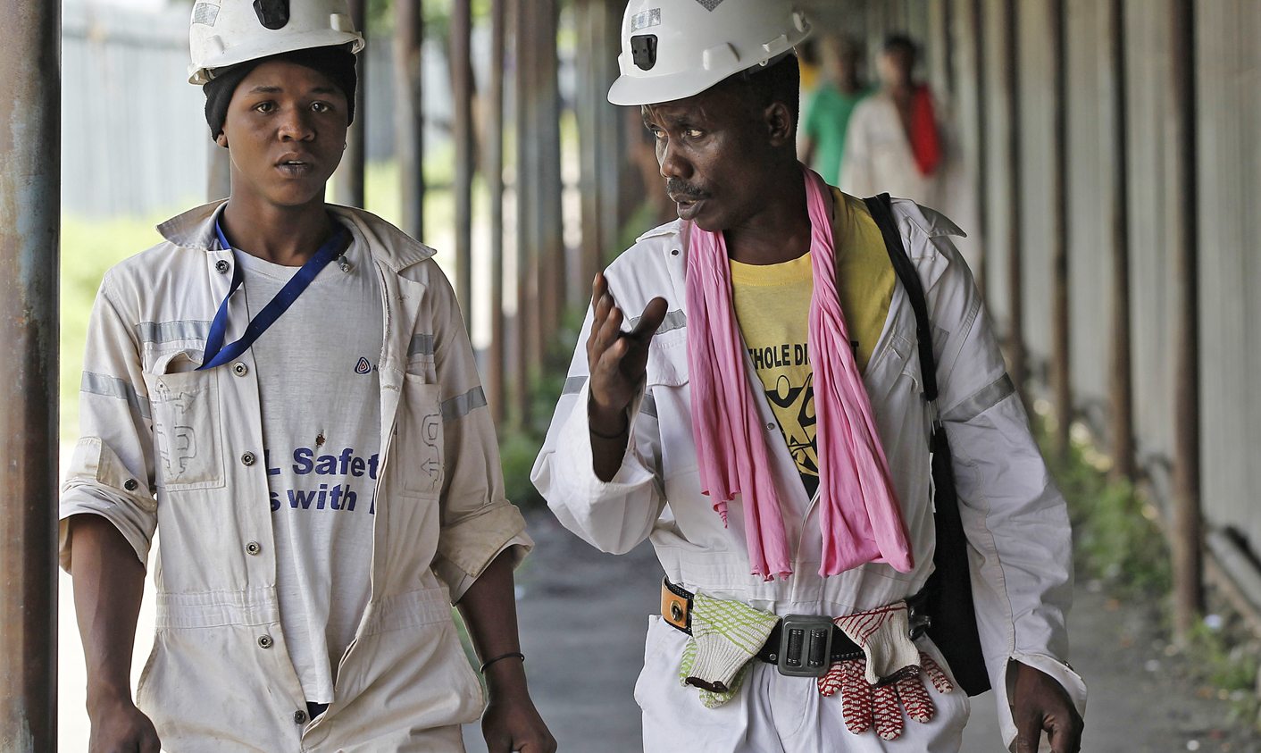 Miners walk at the end of their shift at the Anglo Platinum's Khuseleka shaft 1 mine in Rustenburg, northwest of Johannesburg