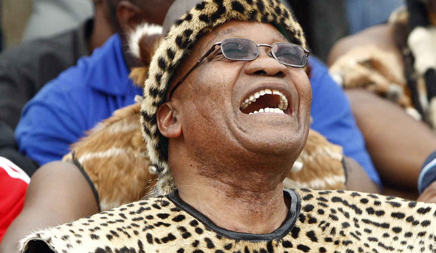 South African President Zuma shares a joke with a family member during his traditional wedding to Madiba, his fifth wife, in Nkandla