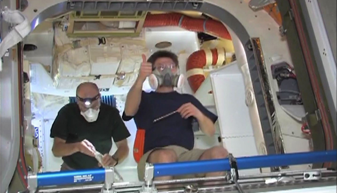 Astronauts float inside SpaceX Dragon capsule
