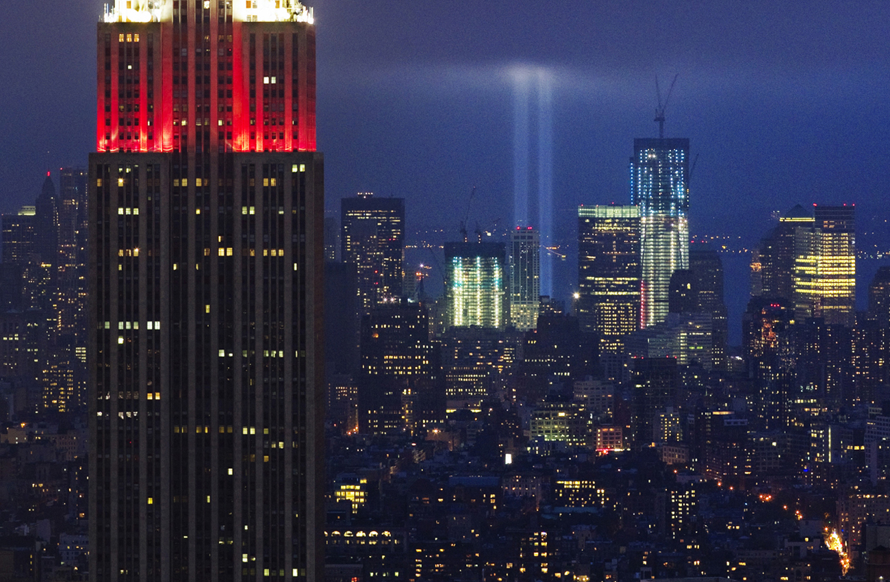 The Tribute in Lights shines behind the Empire State Building during events marking the 10th anniversary of the 9/11 attacks on the World Trade Center in New York