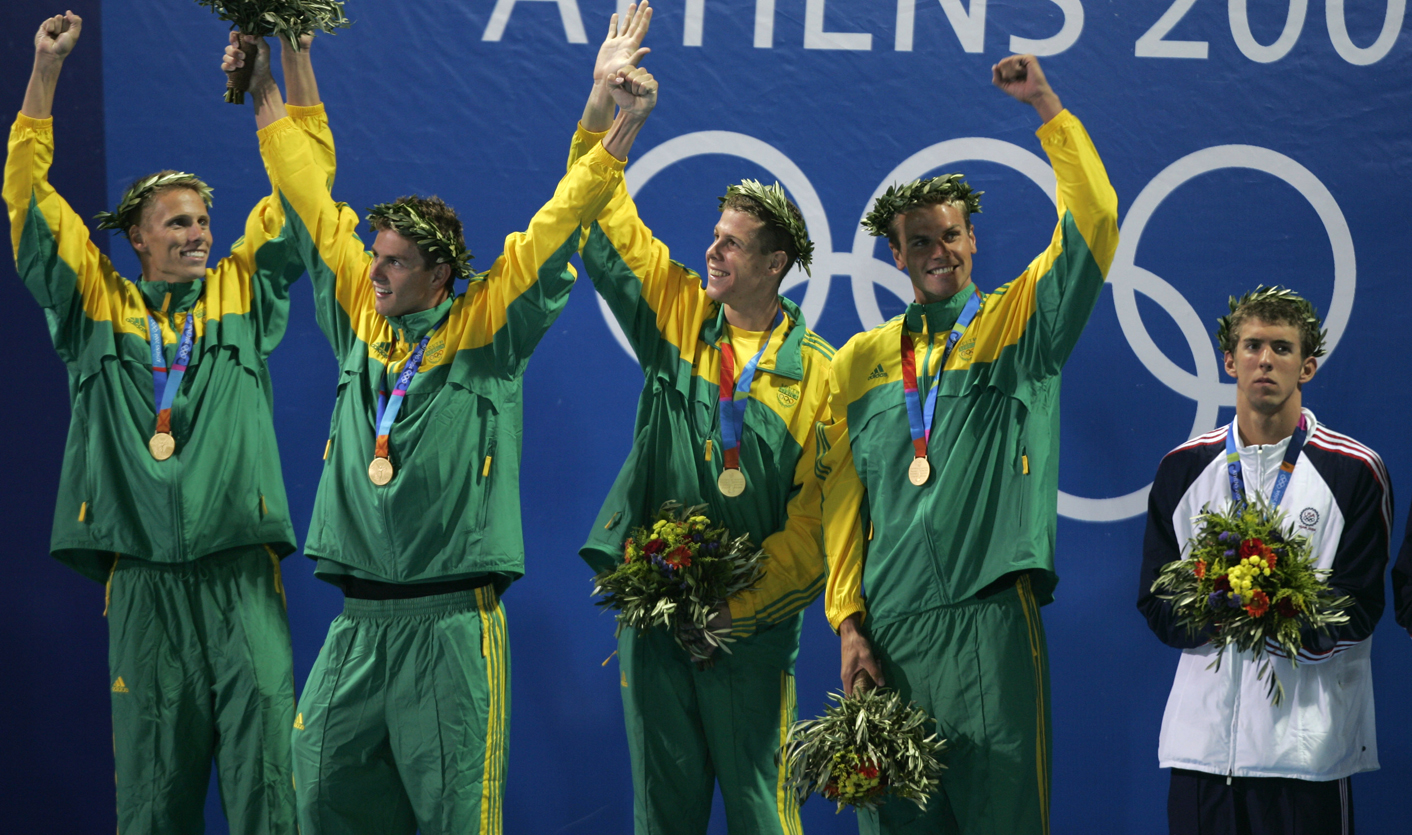 Phelps of the U.S. looks at South Africa 's team celebrating gold medal in the men's 4x100 metres ...