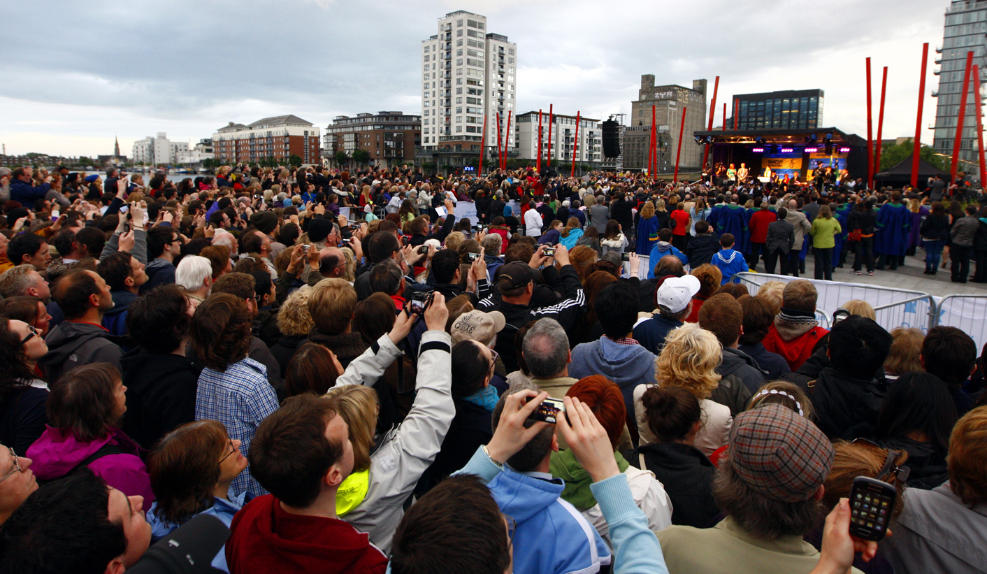 People look on as Myanmar's pro-democracy leader Suu Kyi speaks on stage after she received the Freedom of the City of Dublin, in Dublin