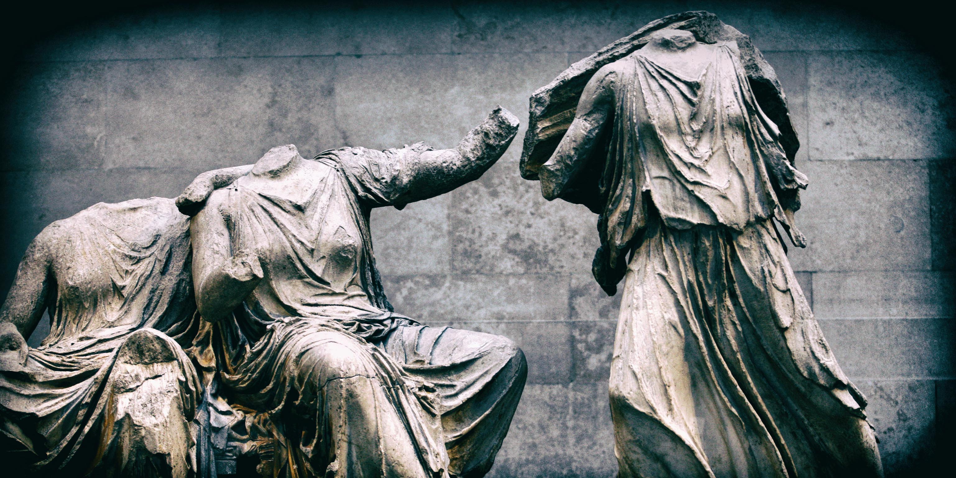 A visitor passes part of the Elgin Marbles collection at the
