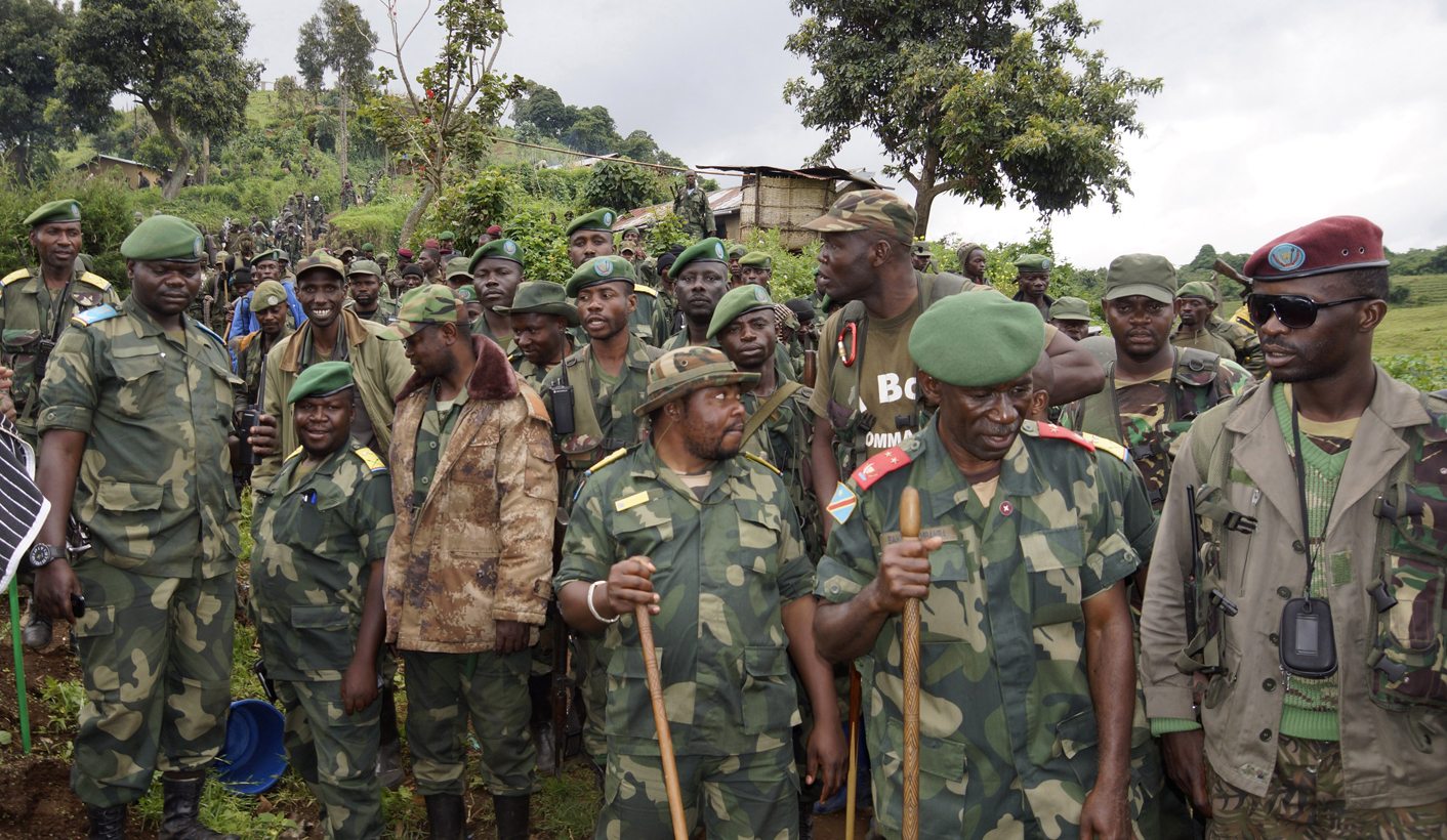 Congolese soldiers gather for a military briefing after M23 rebel fighters surrendered, in Chanzo village in the Rutshuru territory near the eastern town of Goma