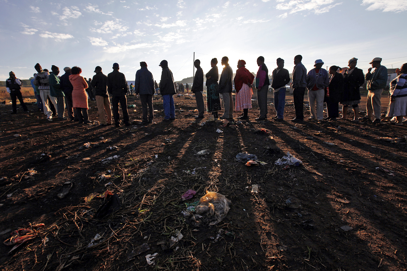 People queue to cast their votes during the South African municipal elections in Soweto