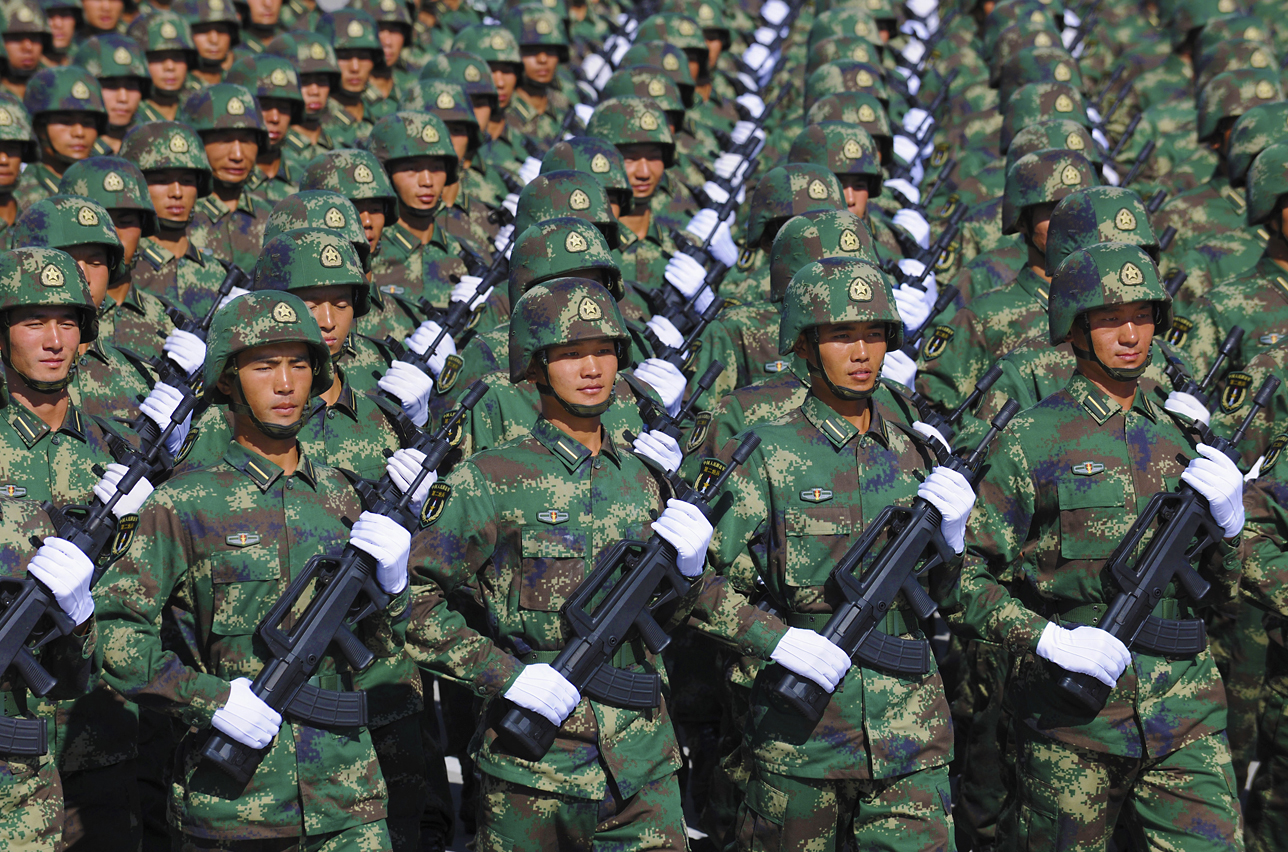 Soldiers from the Chinese People's Liberation Army Second Artillery Corps march in formation during a training session at the 60th National Day Parade Village in the outskirts of Beijing