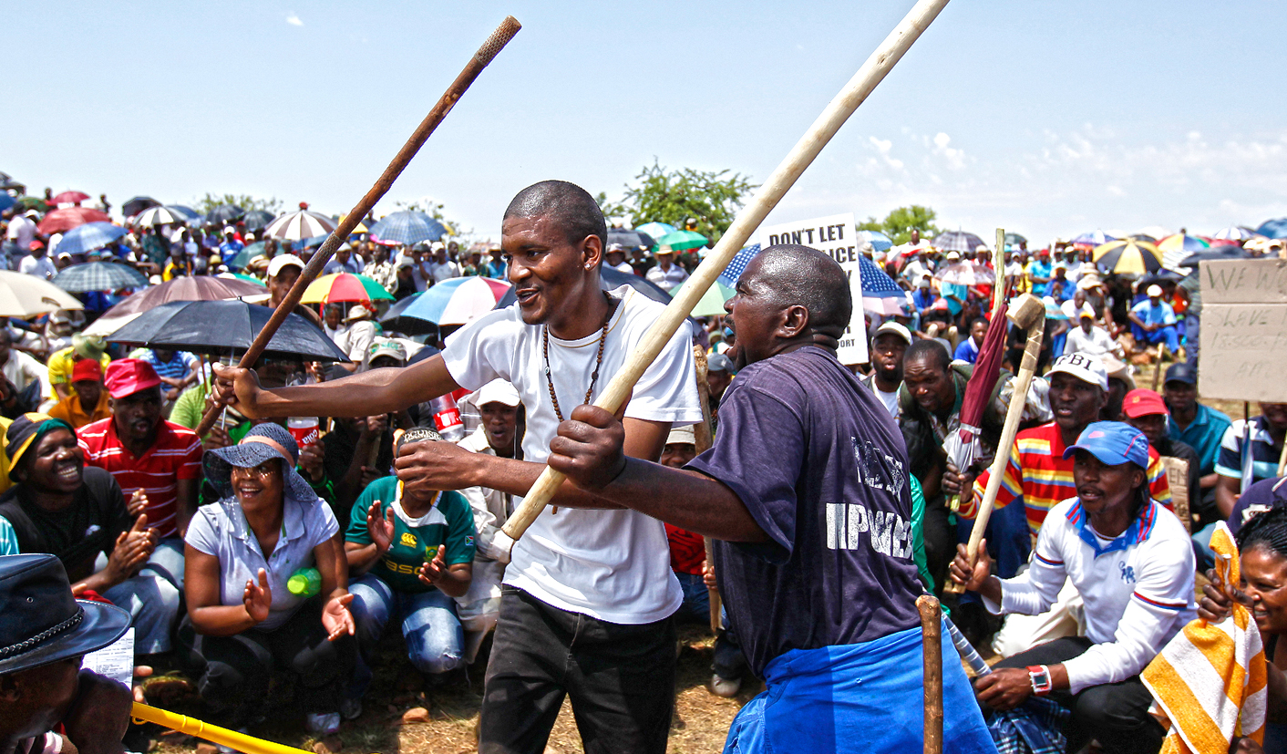 Striking miners sing during a strike at the AngloGold Ashanti mine in Carletonville, northwest of Johannesburg