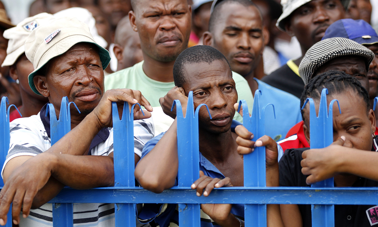 Mine workers listen to Zwelinzima Vavi, COSATU General Secretary, during his address at the Impala Platinum mine in Rustenburg