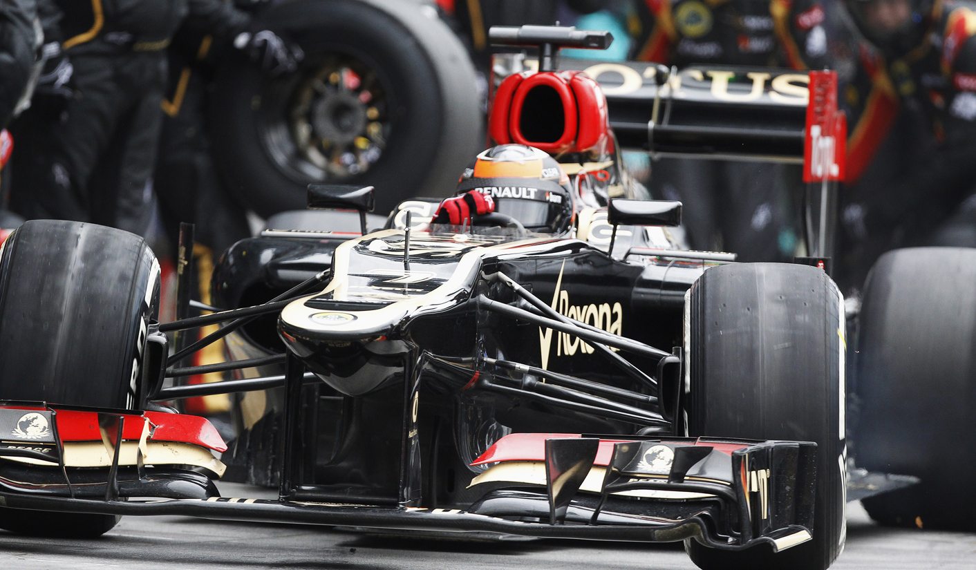 Lotus Formula One driver Kimi Raikkonen of Finland drives in the pit lane during the Australian F1 Grand Prix at the Albert Park circuit in Melbourne