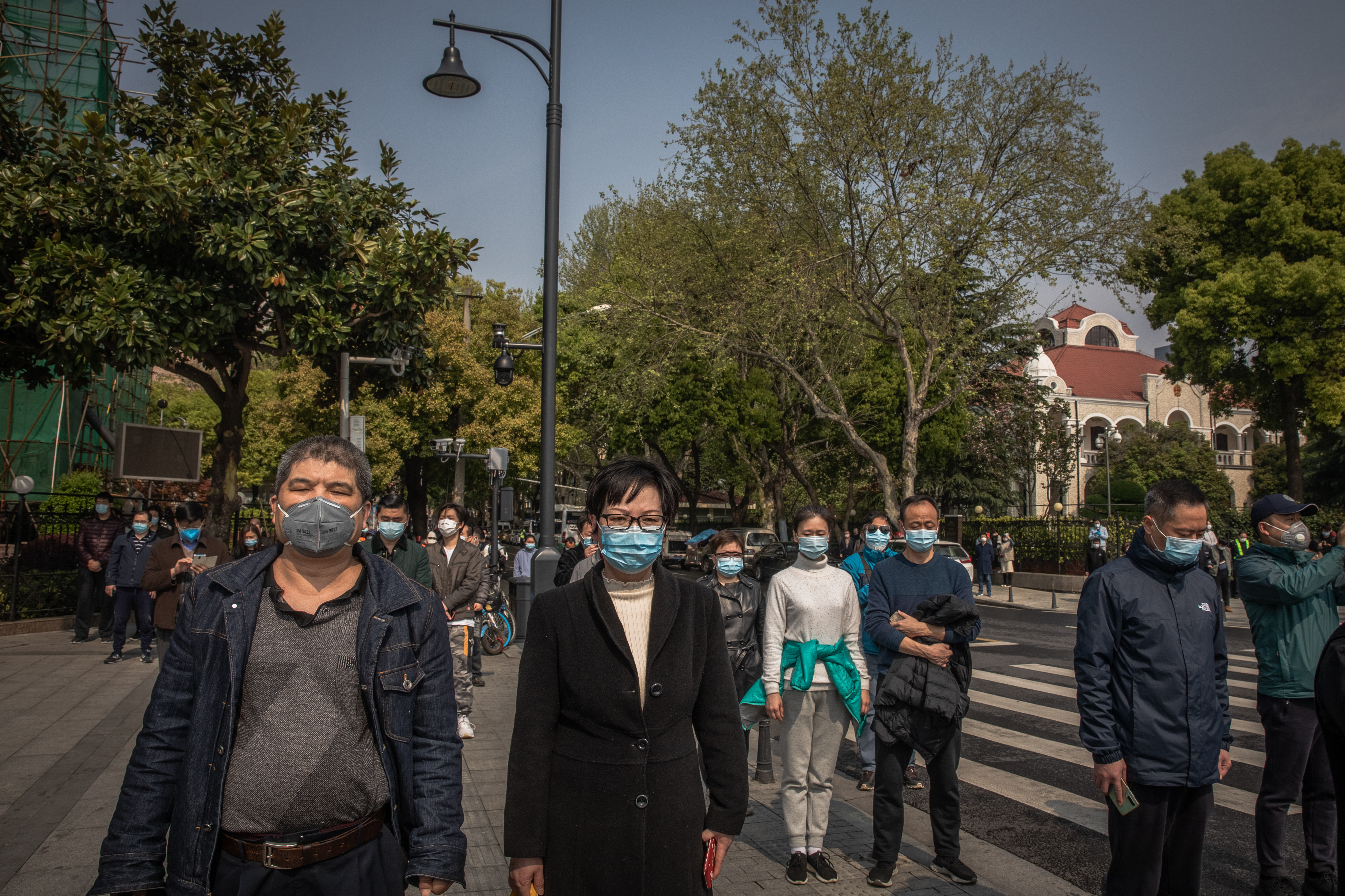 People observe three minutes of silence for victims of COVID-19, in China