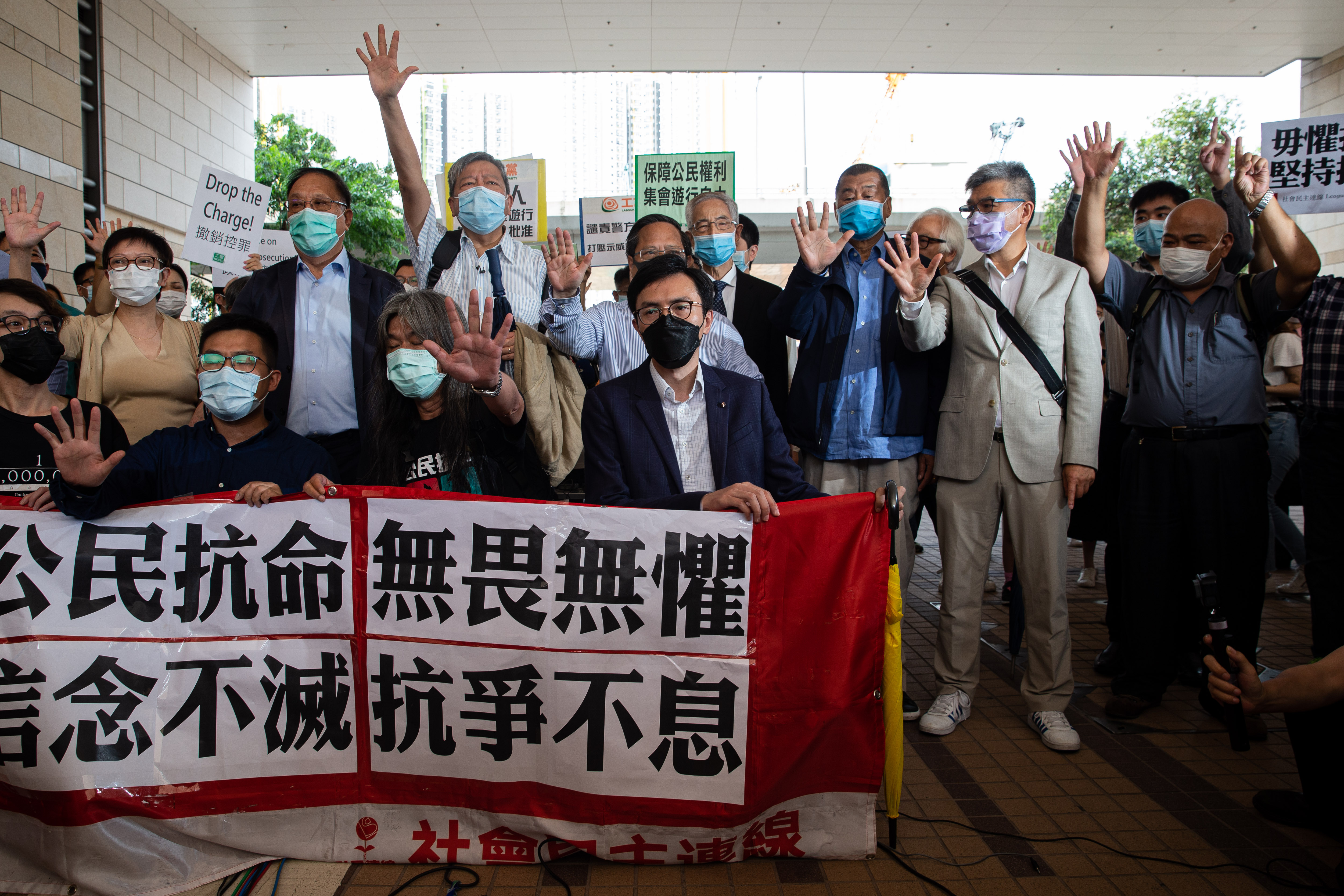 Hong Kong's veteran pro-democracy activists defiant as they hear charges in court