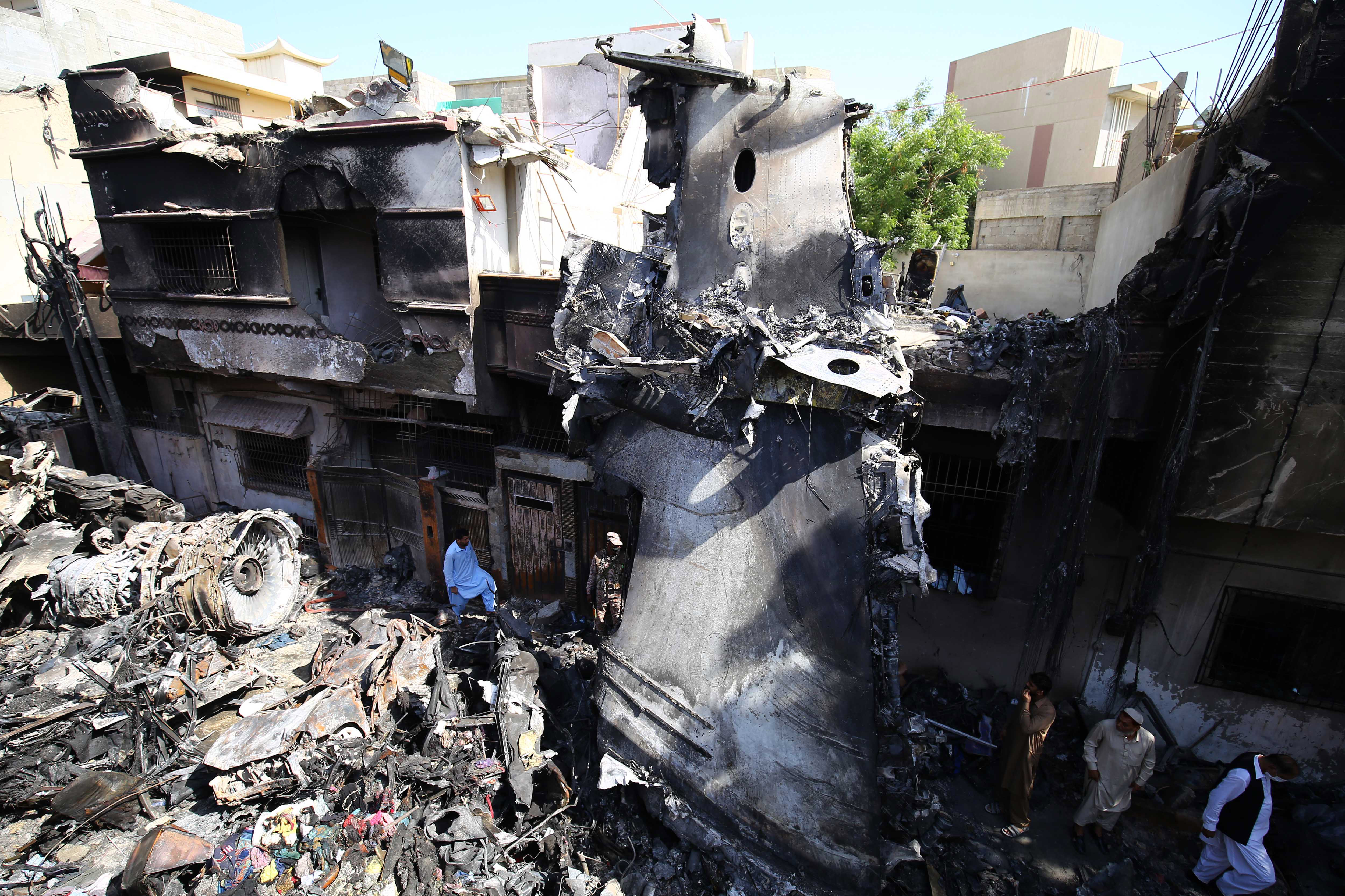 Aftermath of PIA Airbus A-320 that crashed in Karachi killing at least 97 people.