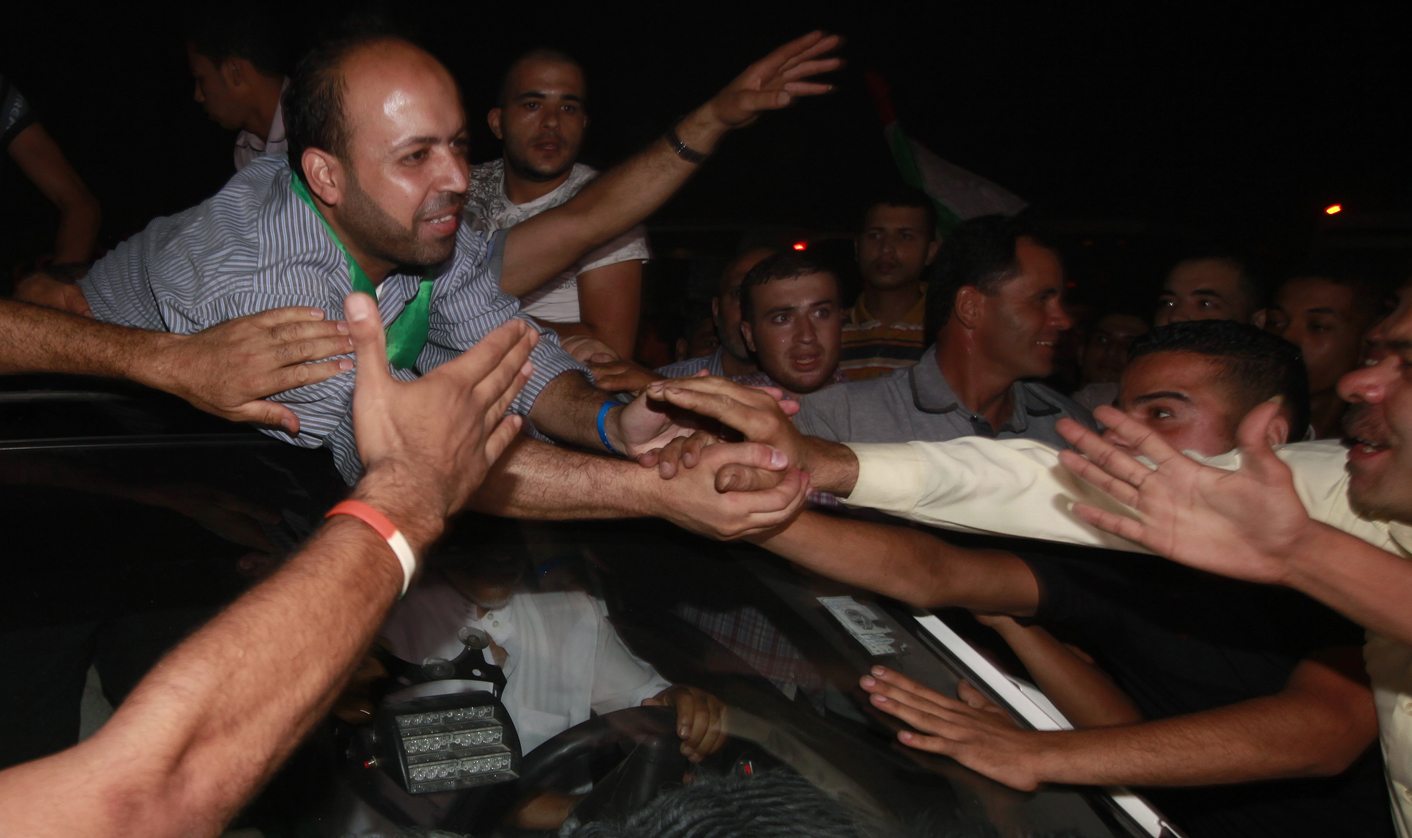 A freed Palestinian prisoner is greeted upon his arrival near Erez Crossing