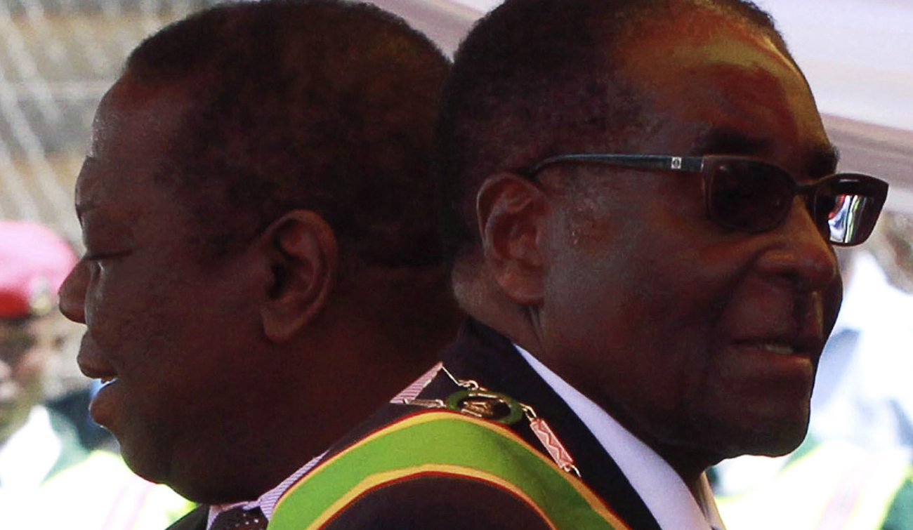 Zimbabwean President Robert Mugabe and Prime Minister Morgan Tsvangirai arrive at a rally marking Zimbabwe's 31st independence anniversary celebrations in Harare