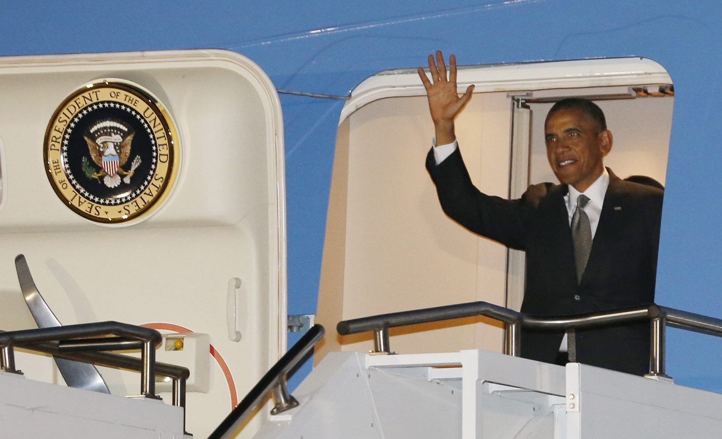 U.S. President Barack Obama waves while arriving at Waterkloof Air Base in South Africa