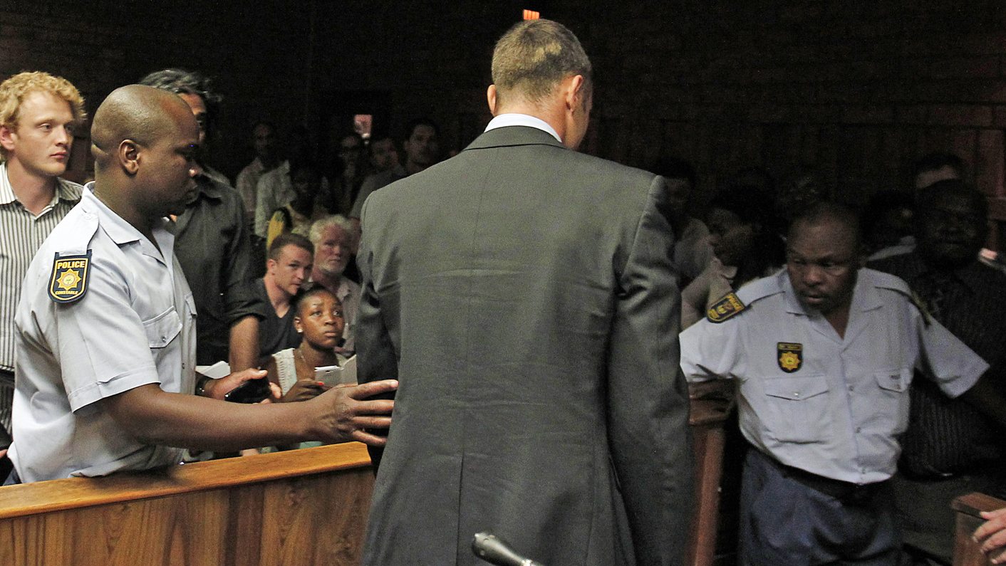 South African 'Blade Runner' Oscar Pistorius is escorted by police during his court appearance in Pretoria