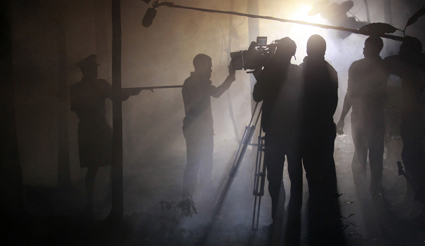 Actors perform a scene at night while filming 'October 1', a police thriller directed by Kunle Afolayan, at a rural location in Akure, southwest Nigeria